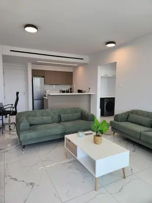 a living room with two green couches and a table at Infinity Luxury Mansions in Yeri