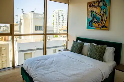 a bedroom with a bed and a large window at Luxury 2BR Center 360 Nicosia with pool, gym, sauna in Nicosia