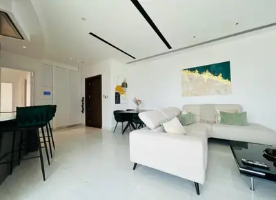 a living room with a white couch and a table at Luxury 2BR Center 360 Nicosia with pool, gym, sauna in Nicosia