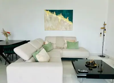 a living room with a white couch and a table at Luxury 2BR Center 360 Nicosia with pool, gym, sauna in Nicosia