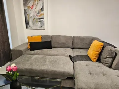 a living room with a gray couch with yellow pillows at Nicosia City Centre City Vibes Luxury 1BD in Nicosia