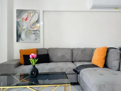 a living room with a couch and a glass table at Nicosia City Centre City Vibes Luxury 1BD in Nicosia