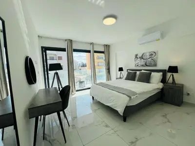 a bedroom with a bed and a desk and a window at Nicosia City Centre City Vibes Luxury 1BD in Nicosia