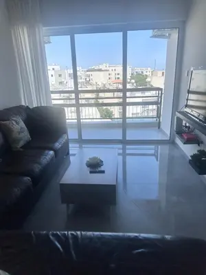 a living room with a couch and a coffee table at Near Finikoudes Beach 3 in Larnaka