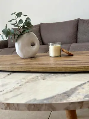 a wooden table with a vase on top of a couch at Seasons Retreat with pool and gym-2BR in Voroklini