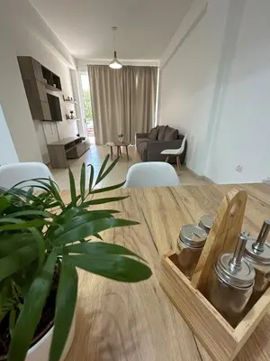 a living room with a table with a plant at Seasons Retreat with pool and gym-2BR in Voroklini