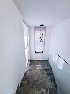 a hallway with a stone floor and a glass staircase at Panorama Luxury Summer Villa in Protaras