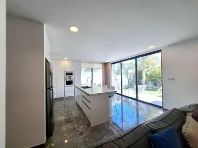 a kitchen and living room with a couch and a refrigerator at Panorama Luxury Summer Villa in Protaras