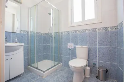 a bathroom with a toilet and a sink and a shower at Protaras Mesogeios Villa Me16 Beachfront Villa in Protaras Center in Protaras