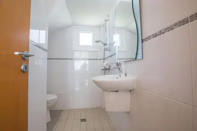 a white bathroom with a sink and a mirror at Protaras Mesogeios Villa Me16 Beachfront Villa in Protaras Center in Protaras