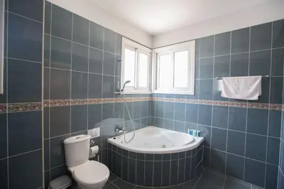 a bathroom with a tub and a toilet and a sink at Protaras Mesogeios Villa Me16 Beachfront Villa in Protaras Center in Protaras