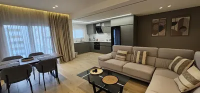 a living room with a couch and a table at Trendy Neapolis Beach Apartment in Limassol