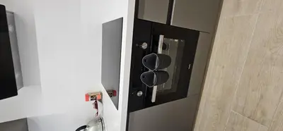 a bathroom with a black cabinet with a mirror at Trendy Neapolis Beach Apartment in Limassol