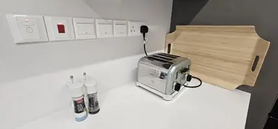 a kitchen counter with a toaster and a toaster at Trendy Neapolis Beach Apartment in Limassol
