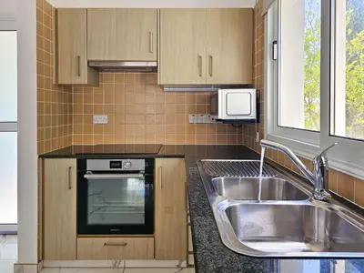 a small kitchen with a sink and a stove at Nissi beach villa Azure in Ayia Napa