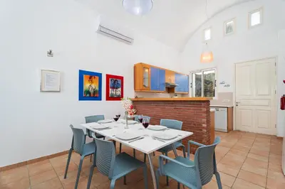a kitchen and dining room with a table and chairs at Villa Zina by Ezoria Villas in Meneou