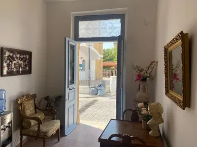 a room with an open door with a chair and a table at ToHaniMou - Kamara Medium Studio in Nicosia