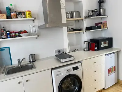 a kitchen with a washing machine and a sink at ToHaniMou - Kamara Medium Studio in Nicosia