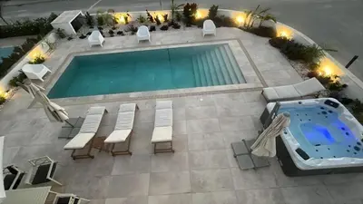 an overhead view of a swimming pool with chairs and a table at Nadine sea side villas in Larnaka