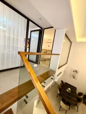 a room with a staircase and a table and chairs at 3 bedrooms villa with own pool!