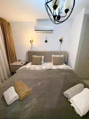 a bedroom with a large bed with two pillows at 3 bedrooms villa with own pool!