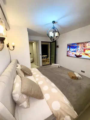 a bedroom with a large bed with a couch at 3 bedrooms villa with own pool!