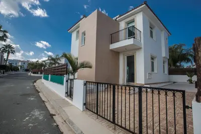 a house with a fence in front of a street at Protaras Holiday Villa Me25 in Protaras