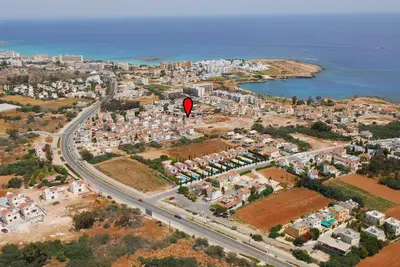 a red object flying over a city with a road at Protaras Holiday Villa Me25 in Protaras