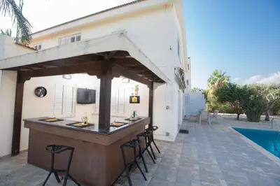 a bar in the backyard of a house at Ayia Napa Holiday Villa At26 in Ayia Napa