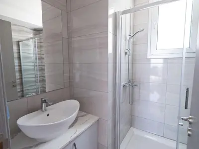 a white bathroom with a sink and a shower at Villa Clea,stunning 4bdr Protaras Villa, Seaviews in Protaras