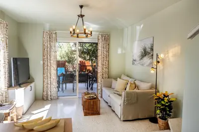 a living room with a couch and a table at Laranca Oneiro Seaside Villa in Pervolia
