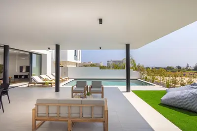 an open living room with a pool and a patio at Protaras Aqua Pearl Villa 9 in Protaras