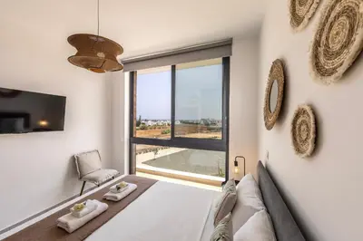 a bedroom with a bed and a large window at Protaras Aqua Pearl Villa 9 in Protaras