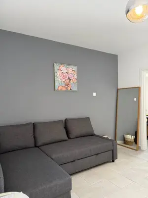 a couch in a living room with a picture on the wall at Ayia Napa 2BR - Prime Location in Ayia Napa