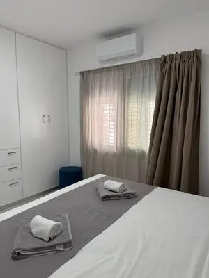 a bedroom with a bed with two towels on it at Ayia Napa 2BR - Prime Location in Ayia Napa