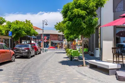 a street with cars parked on the side of the road at Sweet Bonanza Studio in Larnaka