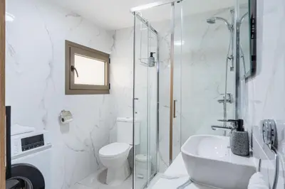 a bathroom with a shower and a toilet and a sink at Sweet Bonanza Studio in Larnaka