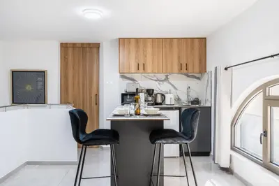 a kitchen with black stools at a kitchen counter at Sweet Bonanza Studio in Larnaka