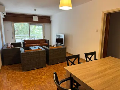 a living room with a couch and chairs and a table at River Court, Flat 8 in Nicosia
