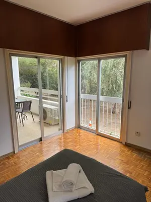 a room with a bed and sliding glass doors at River Court, Flat 8 in Nicosia