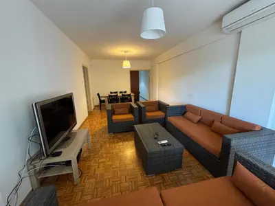 a living room with a couch and a television at River Court, Flat 8 in Nicosia