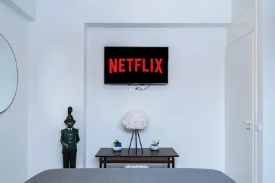 a bedroom with a netflix sign on the wall at Central & Cozy Larnaca Suite in Larnaka