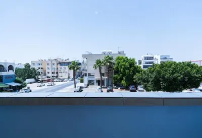 a view of a city street with cars and buildings at Central & Cozy Larnaca Suite in Larnaka