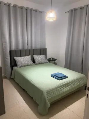 a bedroom with a bed with curtains and a chandelier at Sweet Home Apartment 3-Bedrooms in Larnaka