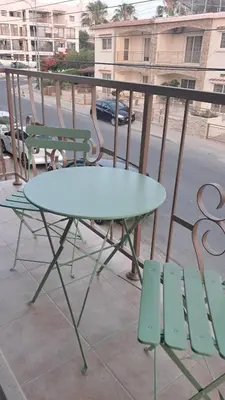 a table and chairs sitting on top of a balcony at Sweet Home Apartment 3-Bedrooms in Larnaka