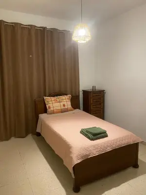 a bedroom with a bed and a chandelier at Sweet Home Apartment 3-Bedrooms in Larnaka