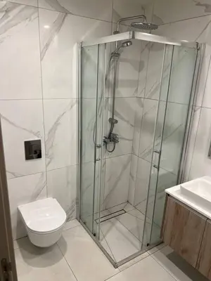 a bathroom with a shower with a toilet and a sink at Modern Cosy Holiday Apartment in Paralimni
