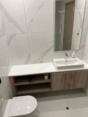 a bathroom with a sink and a toilet and a mirror at Modern Cosy Holiday Apartment in Paralimni