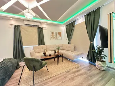 a living room with a couch and a table at Home For You - Holiday Apt Larnaca in Larnaka
