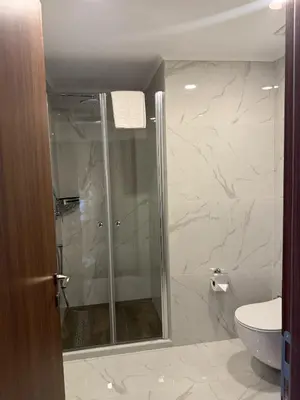 a bathroom with a shower and a toilet at Grand Sapphire Luxury Residence in Iskele